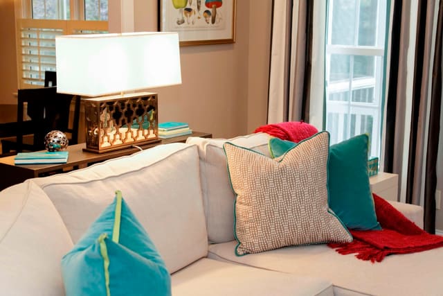 White sectional with colorful throw pillows