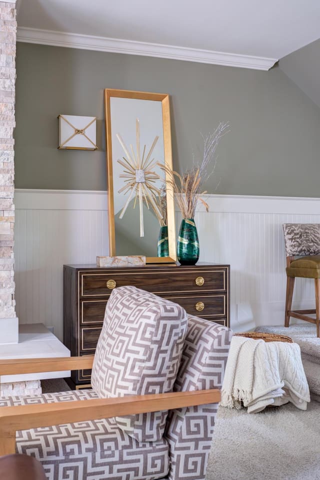 Custom Lillian August chest accompanied by a mirror and other decor pieces.