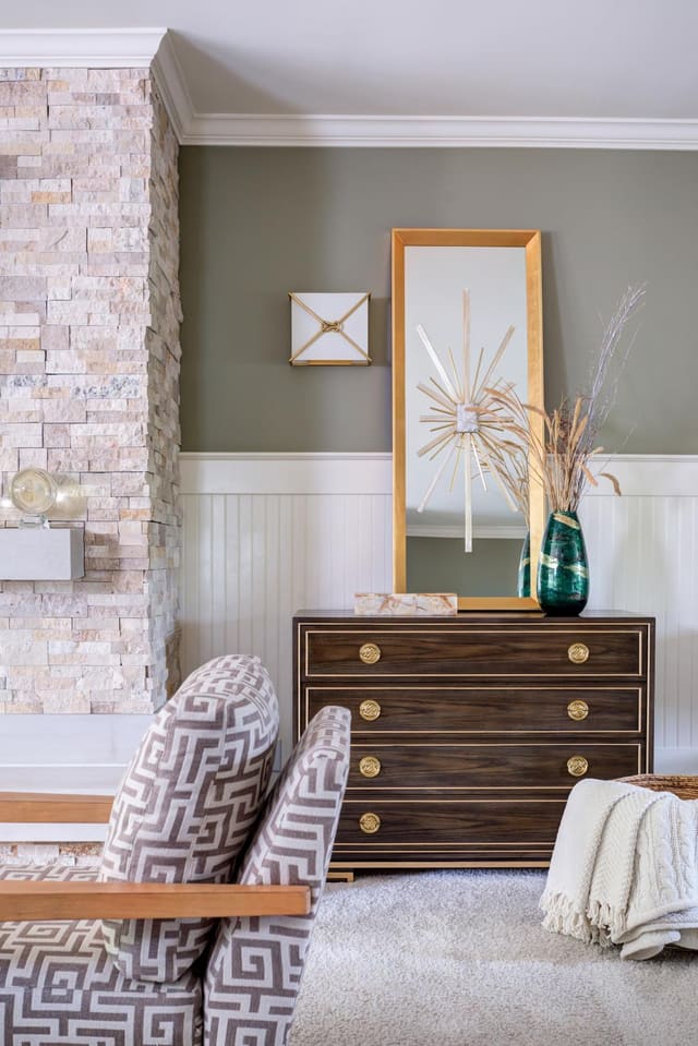 Custom Lillian August chest accompanied by a mirror and other decor pieces.