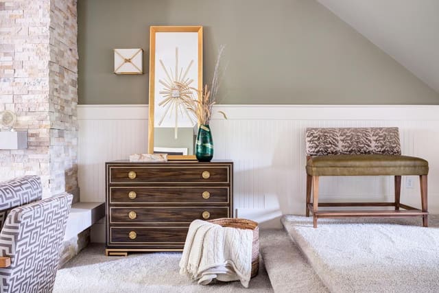 Custom Lillian August chest accompanied by a mirror and other decor pieces.