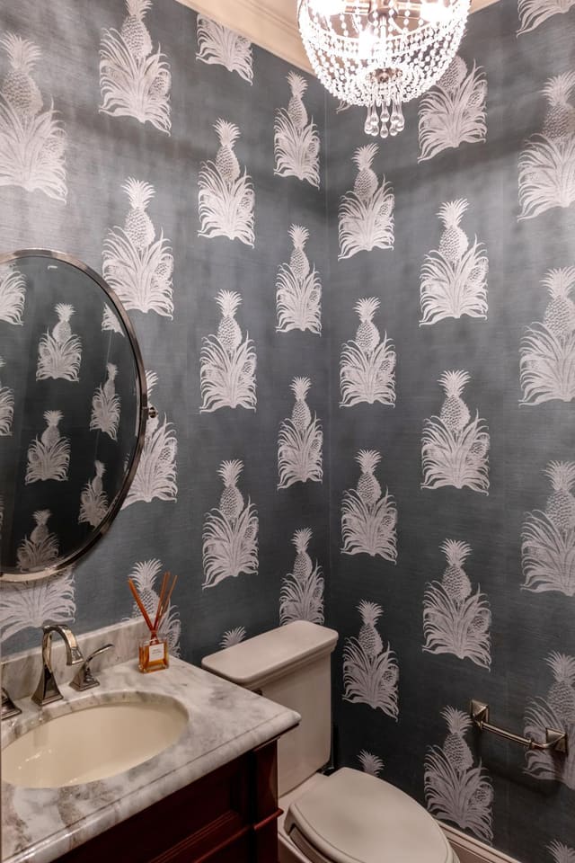 Powder bath with a Studio Printworks wallpaper.