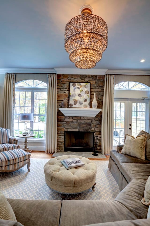 Family Room with blue ceiling, elegant furnishings, stunning chandelier and drapery panels with tape trim