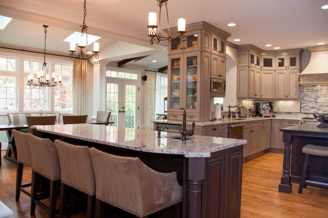 Remodeled Kitchen with granite countertops, taupe cabinets, and dark wood islands