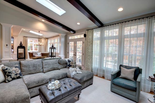 Elegant Family Room with beautiful drapery panels and sheer window treatments