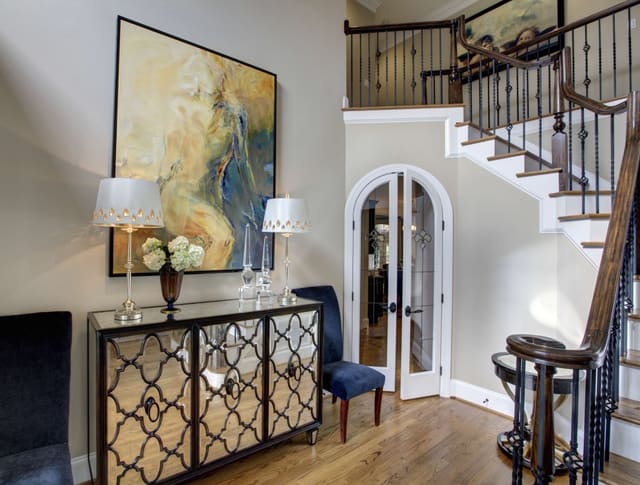 Foyer with mirrored chest and abstract artwork