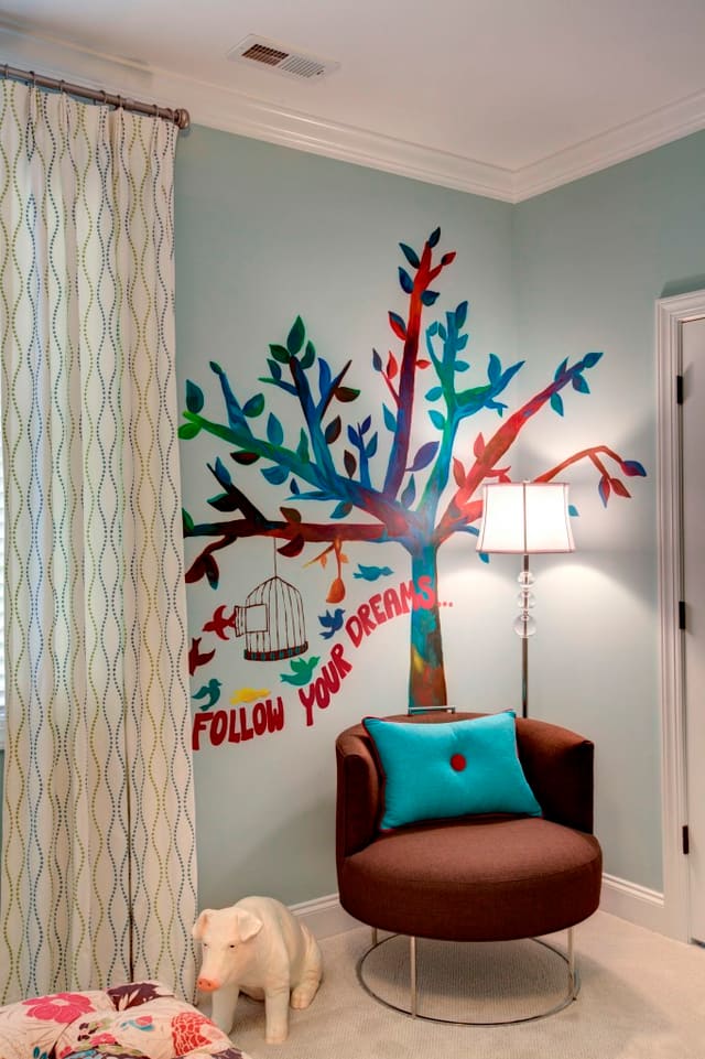 Girls bedroom with painted wall mural, drapery panels, and funky chair