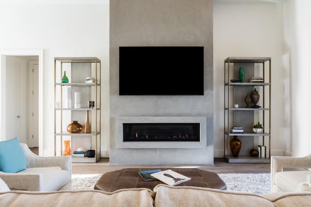 Family Room of Apex Home featuring linear fireplace with flanking etageres.