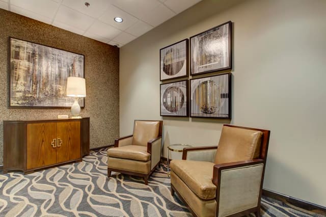 2nd Reception Area of Cary Bank with Two Tone leather chairs and clipped corner chest.