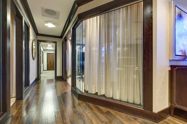 Hallway of Cary Bank, looking into Conference Room, shielded with interior window treatments.
