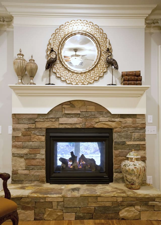 Elegant Living Room with mirror over two-way fireplace