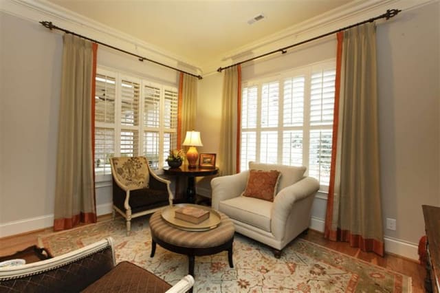 Inviting Sun Room with custom window treatments with contrast banding