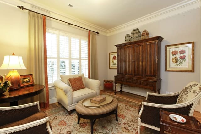 Inviting Sun Room with custom window treatments with contrast banding