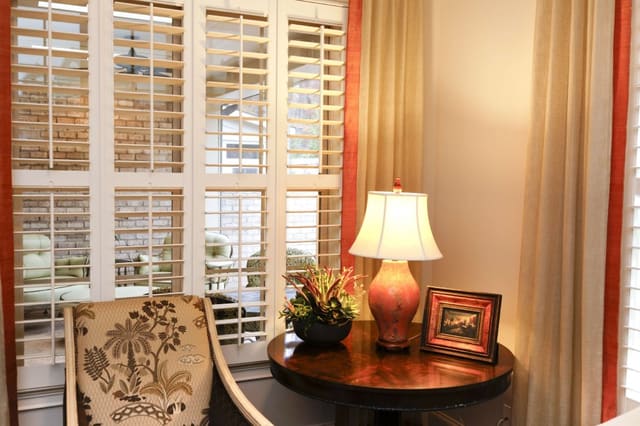 Inviting Sun Room with custom window treatments with contrast banding
