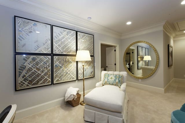 Cute loft with framed map series, chaise, and large gold mirror