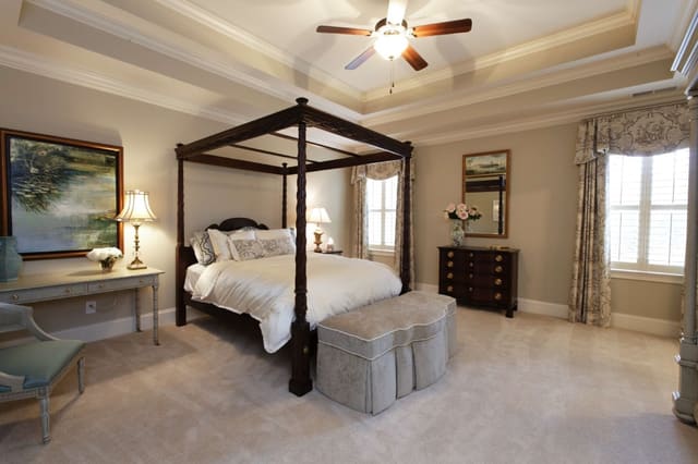 Lovely Master Bedroom with Dark Wood Bed, Drapery Panels with Cornices, and Original Arwork