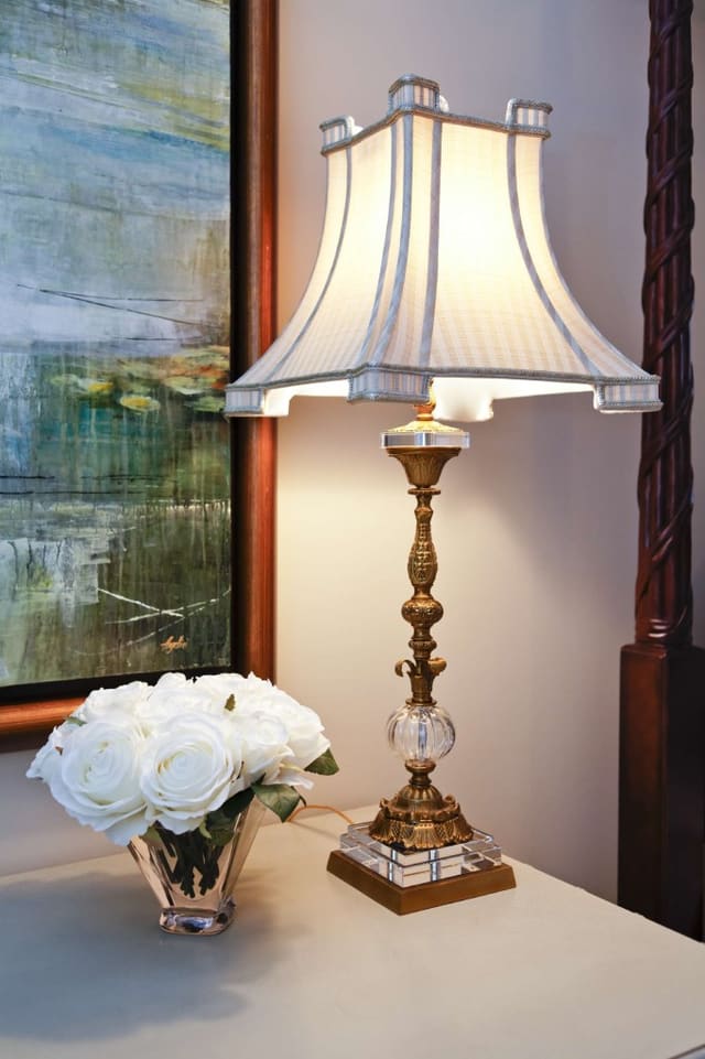 Lamp and floral arrangement beside bed in Master Bedroom