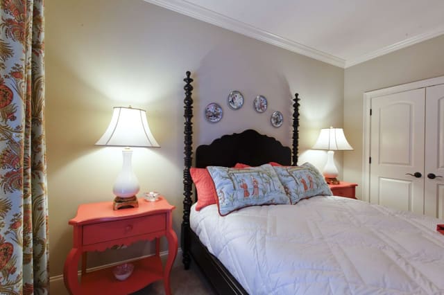 Aqua and Coral colors in Guest Bedroom with plates on wall as art