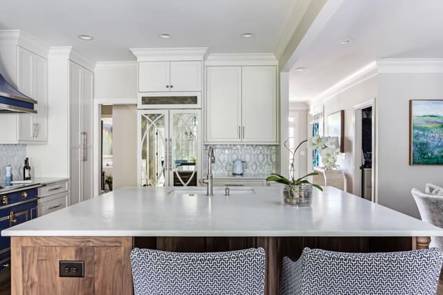 Kitchen with stained island with white countertops