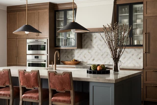 Contemporary kitchen with blue-gray island and statement pendants