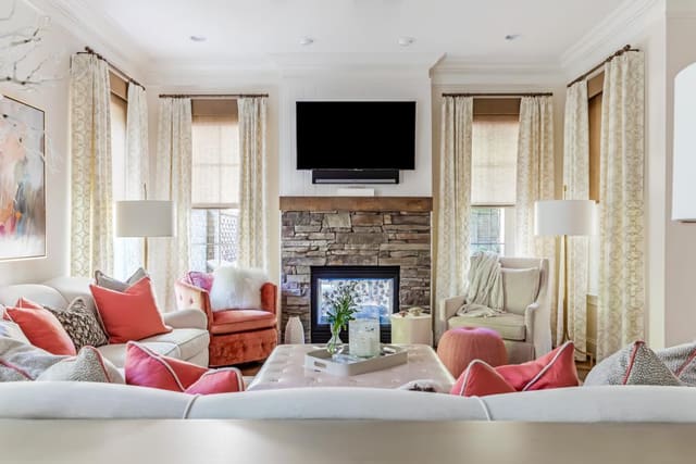 Living Room featuring draperies and furnishings with coral accents