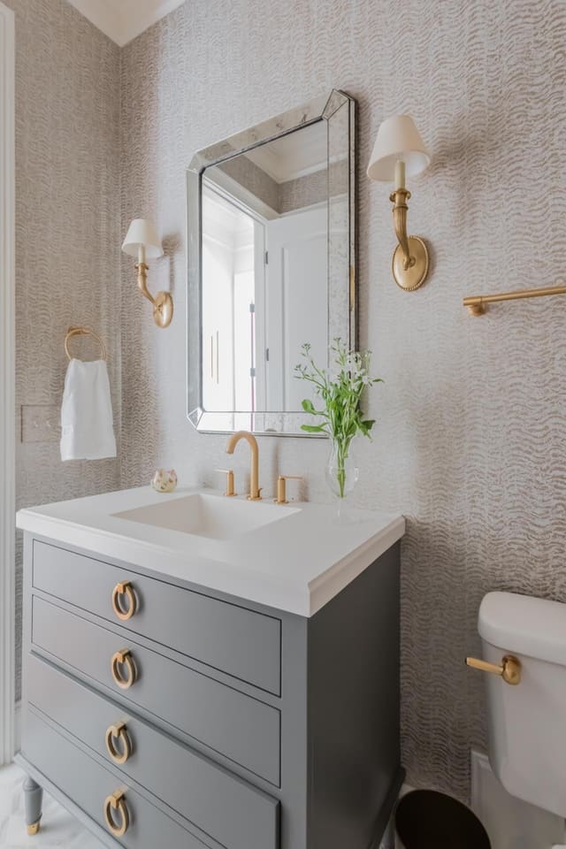 Powder Bath with wallpaper, painted grey vanity and gorgeous brass hardware and lighting.