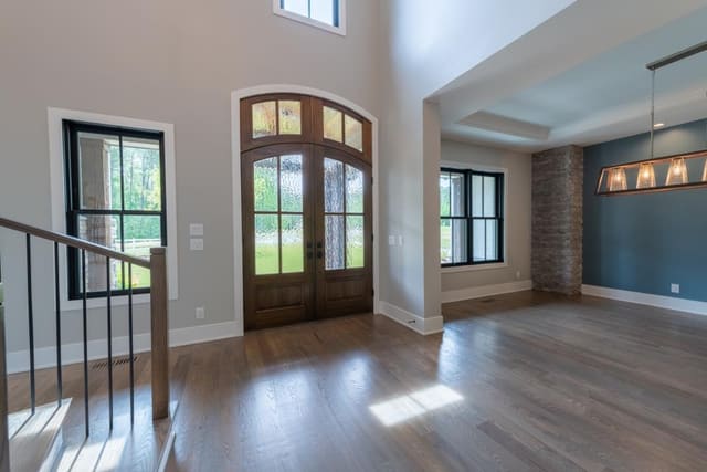 Foyer with Arch-Top Double Entry Doors overlooking Dining Area