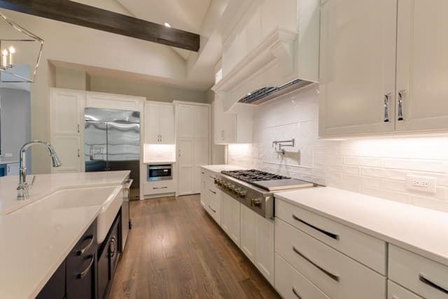 Kitchen with with Cabinetry and Herringbone Backsplash