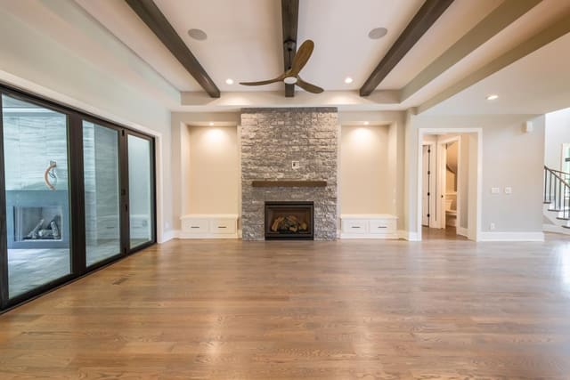 Open Concept Living Area with Exposed Ceiling Beams