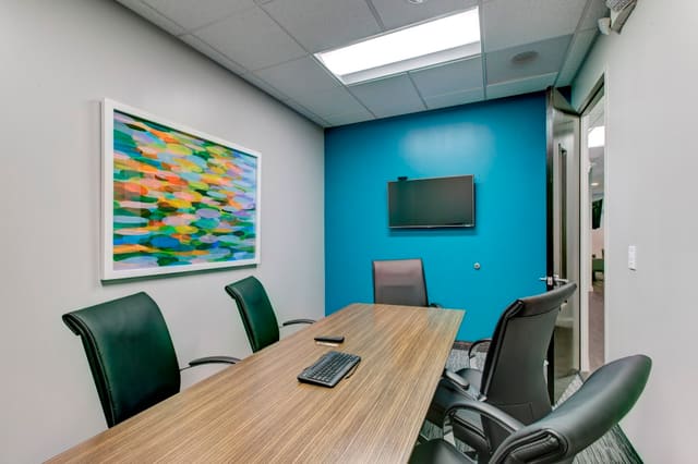 Small Conference Room with bright artwork and turquoise wall