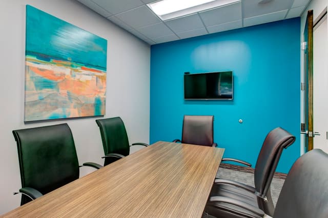 Small Conference Room with bright artwork and turquoise wall