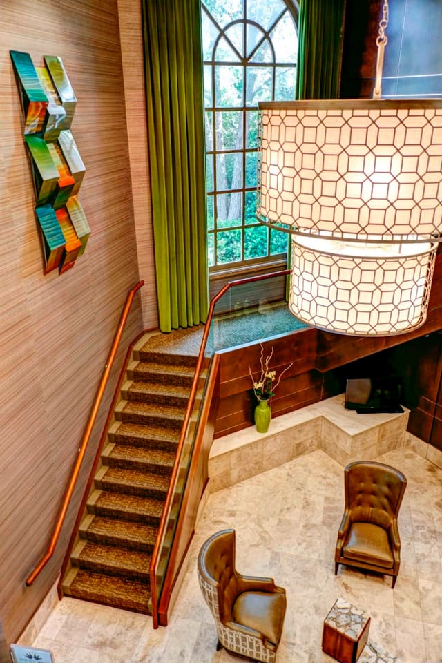 Lobby of Paragon Bank with custom chandelier and window treatments, metal artwork, wallpaper and marble floors