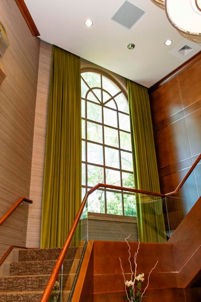Remodeled interior of Paragon Bank with tall velvet drapery panels, wallpaper, and wood panelling