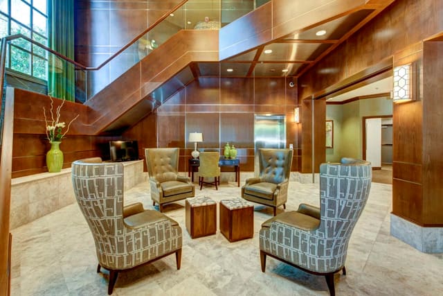 Remodeled Lobby of Paragon Bank with marble floors, wood paneling, and custom furnishings