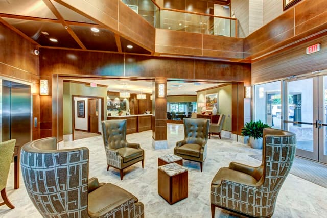 Remodeled Lobby of Paragon Bank with marble floors, wood paneling, and custom furnishings