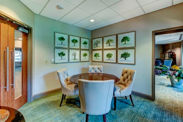 Tufted Back Dining Chairs with table and Tree artwork series in Private Dining Room at Paragon Bank