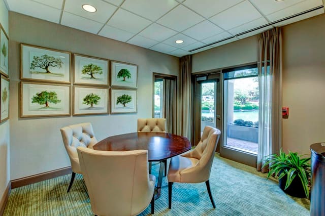 Tufted Back Dining Chairs with table, sheer window treatments, and Tree artwork series in Private Dining Room at Paragon Bank