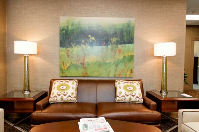 Seating area at Paragon bank with leather sofa and tall lamps