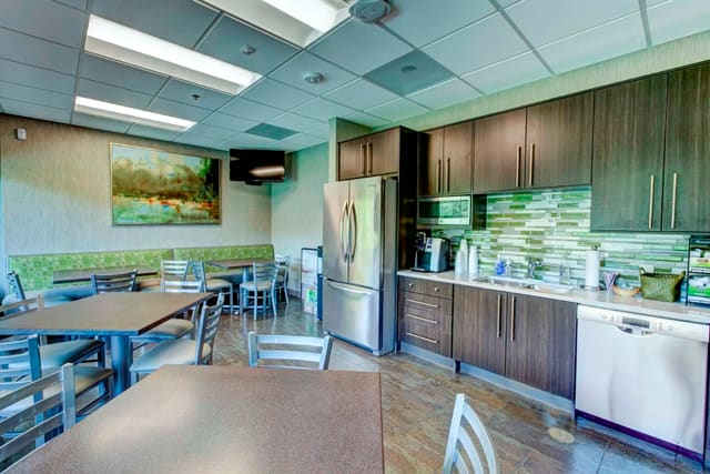 Break Room at Paragon Bank with commercial tables and chairs, sleek cabinetry, banquettes, and fun tile backsplash