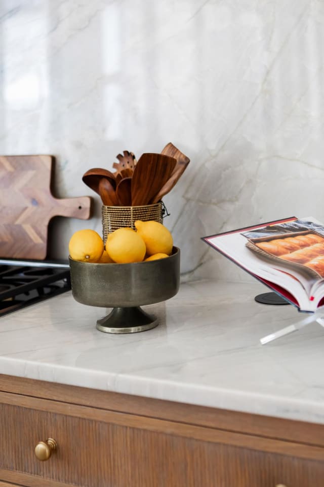 Marble countertops and warm wood cabinetry