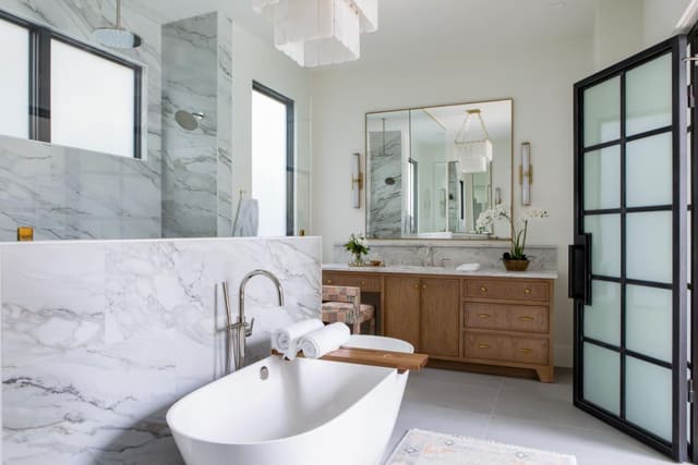 Master Bath with white chandelier and Marble shower