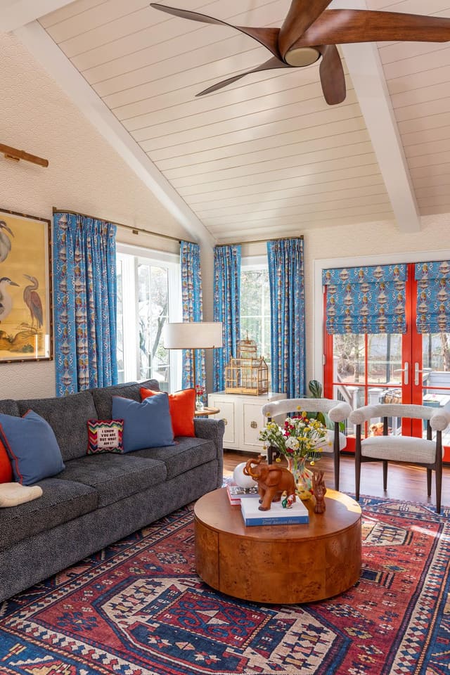 Living room with paneled ceiling and abstract area rug