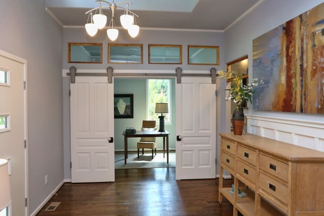 Foyer in Downtown Raleigh Bungalow, with track doors leading to Study