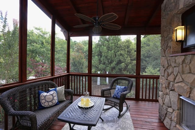 Screened porch in downtown Raleigh home with outdoor fireplace