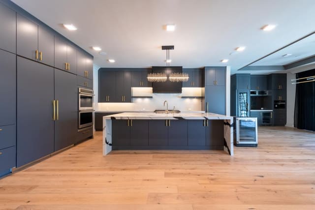 Kitchen with Deep Blue Cabinets and Gold Hardware