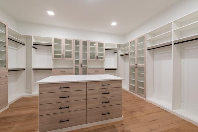 Master Walk-in Closet with Light Wood Finish