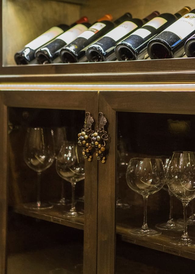 Wine rack and wine glass storage cabinets in Wine Room, with custom cabinet hardware.