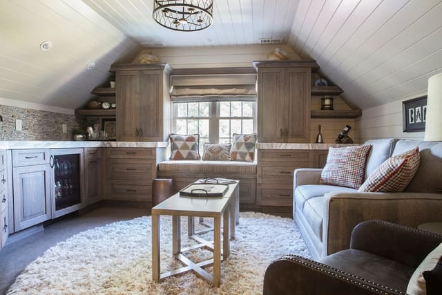 Wine Room lounge off of Wine Room converted from unfinished Attic Space.  Custom furniture, roman shade, window seat, pillows, and shaggy rug.
