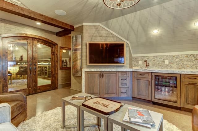 Wine Room Lounge with shaggy rug, custom furniture, window treatment, and pillows, and custom metal artwork.