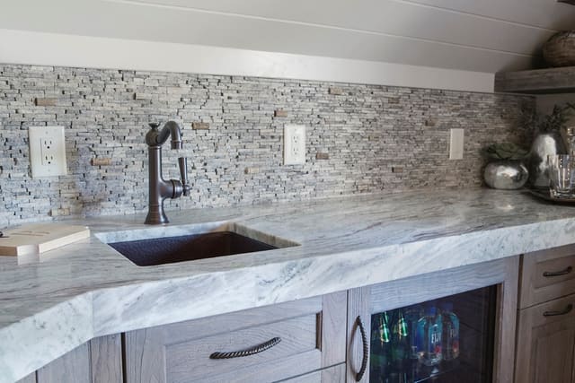 Wine Room lounge off of Wine Room converted from unfinished Attic Space.  Custom backsplash with wine corks inserted between stone pieces.