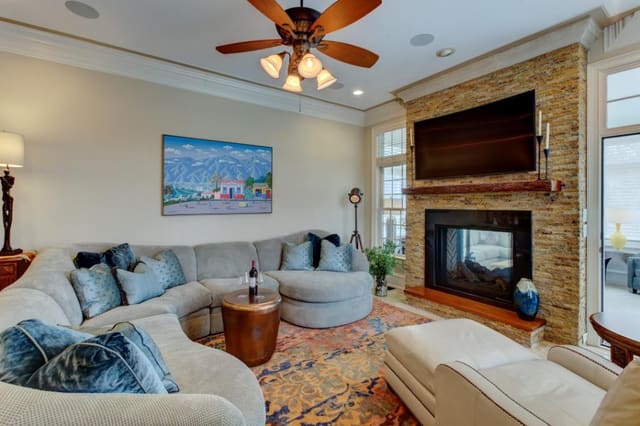 Remodeled Family Room with abstract area rug, leather chair and ottoman, and curved sectional